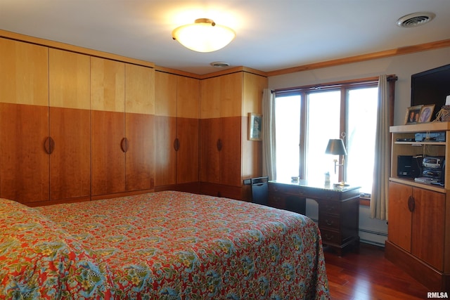 bedroom featuring baseboard heating, crown molding, and dark hardwood / wood-style floors