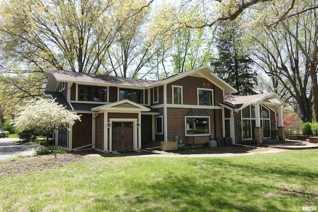128 N Soangetaha Rd, Galesburg, IL 61401 - view of front of home featuring a garage, a front lawn, and roof with shingles