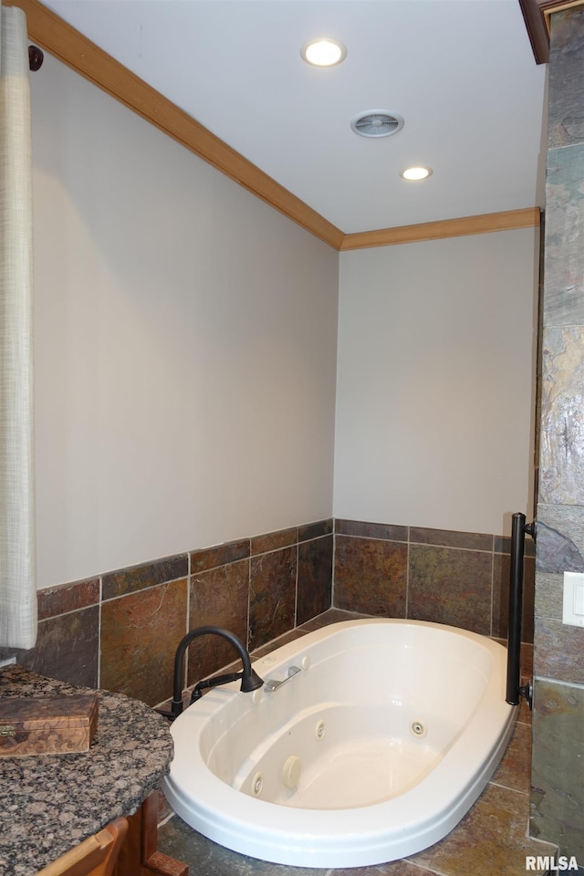 bathroom featuring a relaxing tiled tub and crown molding