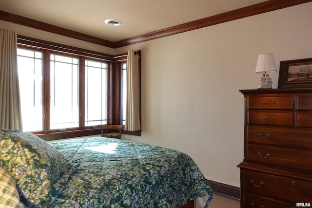 carpeted bedroom featuring crown molding