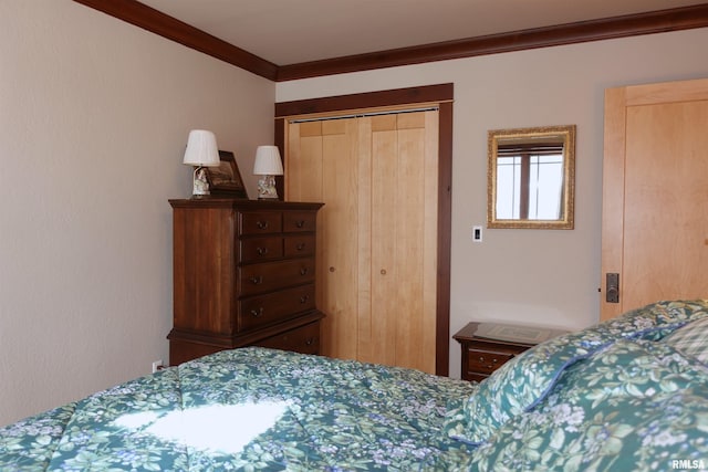 bedroom with a closet and crown molding