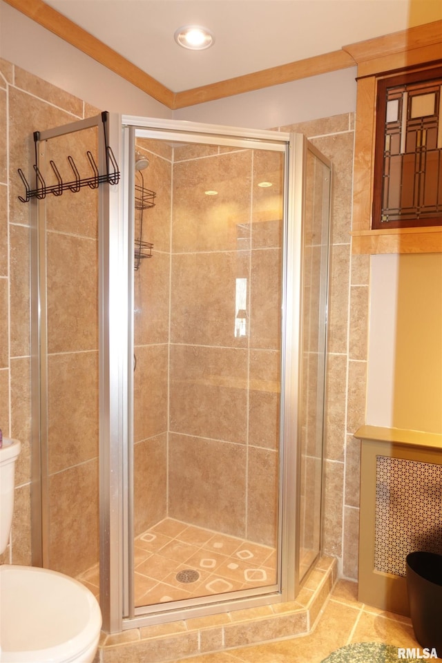 bathroom with toilet, walk in shower, and crown molding