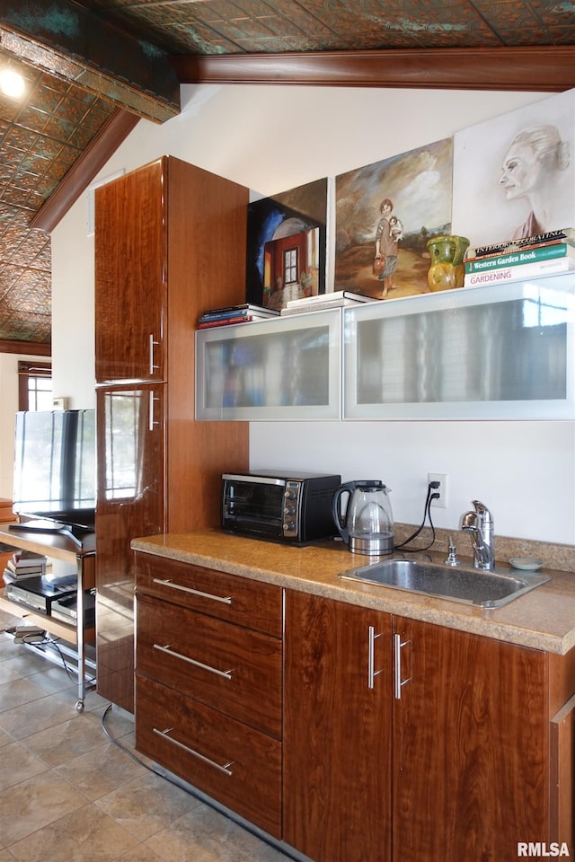 kitchen with sink and lofted ceiling with beams