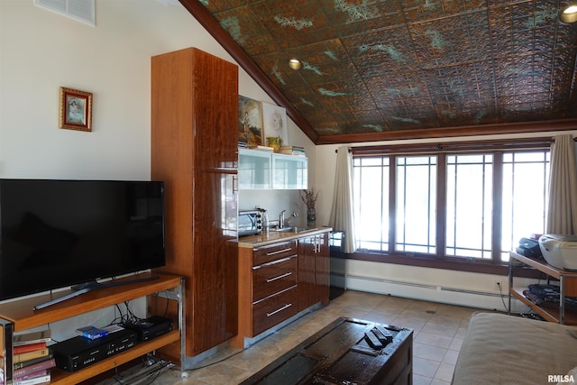 living room featuring sink, a baseboard radiator, light tile patterned floors, and lofted ceiling