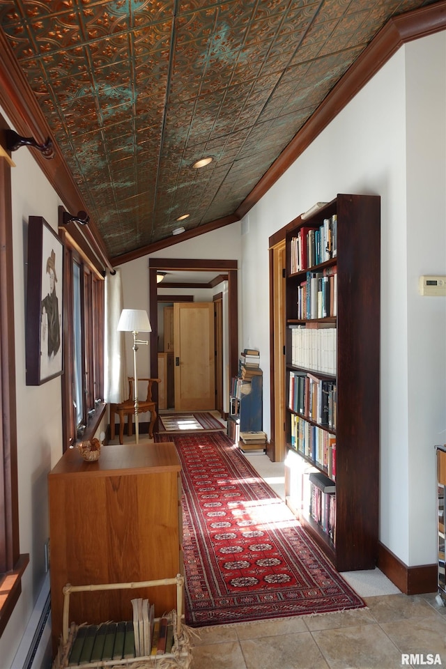 corridor featuring a baseboard radiator, vaulted ceiling, brick ceiling, light tile patterned flooring, and crown molding