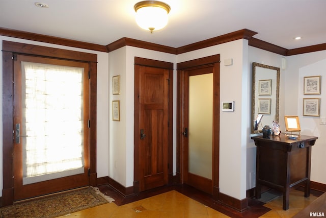 foyer entrance featuring ornamental molding and plenty of natural light