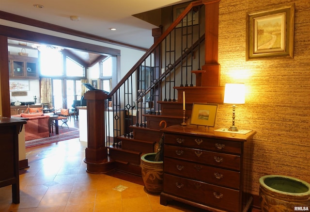 staircase featuring ornamental molding