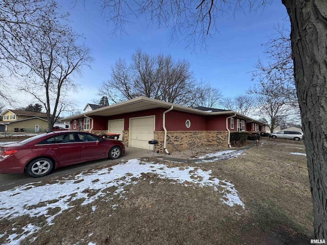 snow covered property featuring a garage