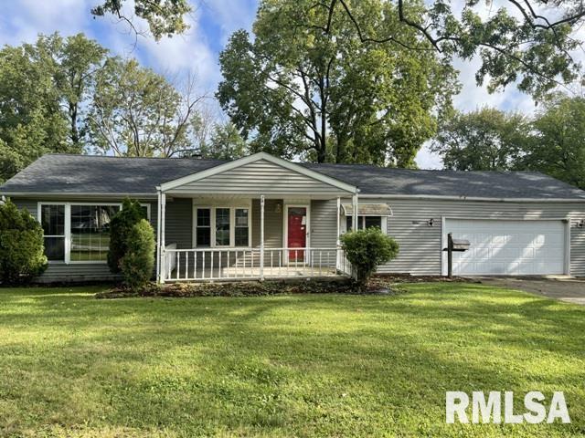 single story home featuring a garage, covered porch, and a front yard