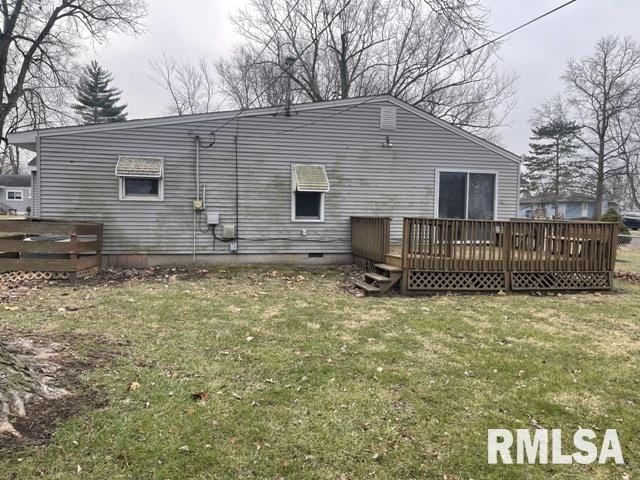 back of house featuring a yard and a deck