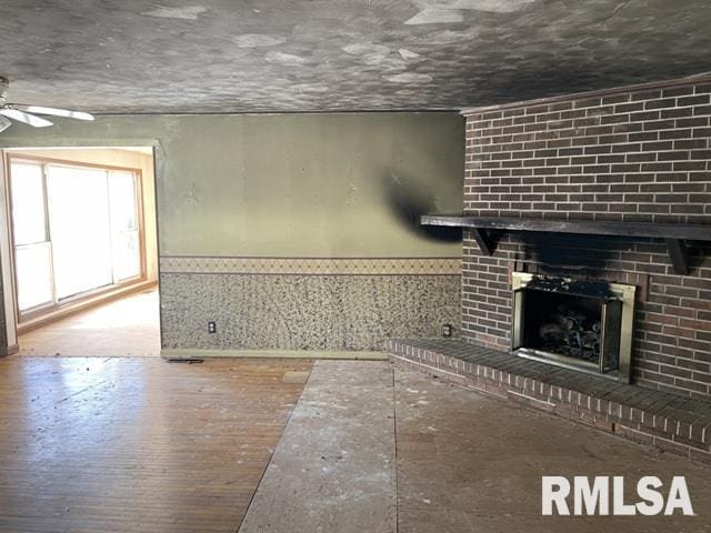 unfurnished living room featuring a fireplace and ceiling fan