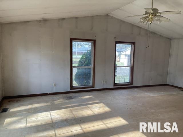 empty room with ceiling fan and lofted ceiling