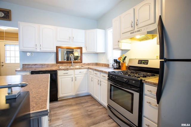 kitchen featuring sink, white cabinets, light wood-type flooring, and appliances with stainless steel finishes