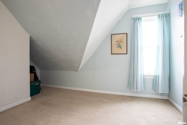 bonus room featuring lofted ceiling, carpet floors, and a wealth of natural light