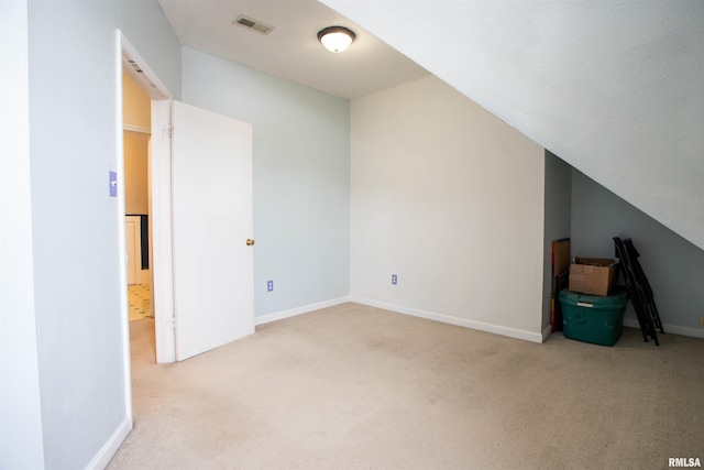 bonus room featuring light carpet and lofted ceiling