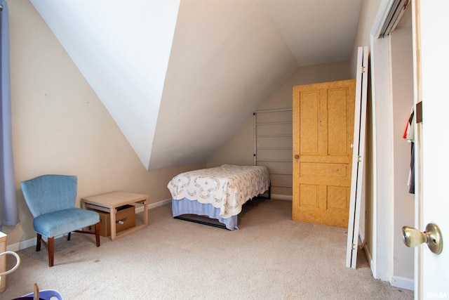 carpeted bedroom featuring lofted ceiling