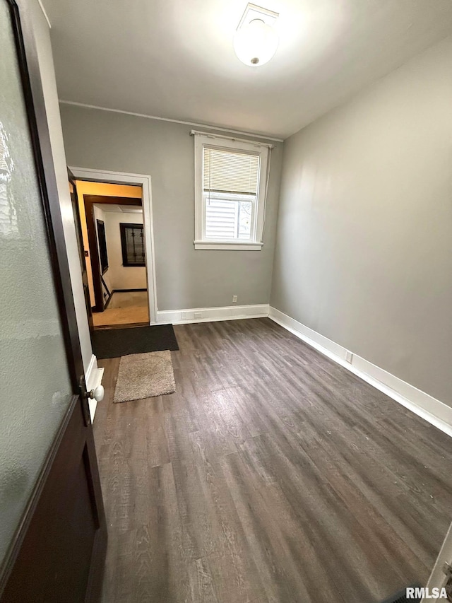 empty room featuring dark wood-type flooring