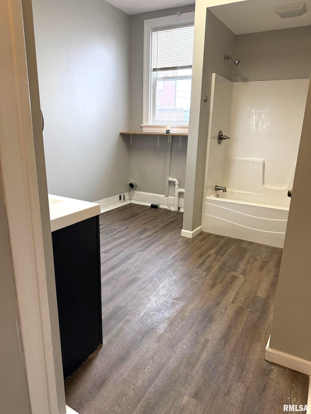 bathroom with vanity,  shower combination, and wood-type flooring