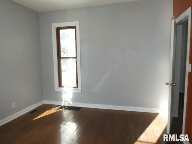 unfurnished room with hardwood / wood-style flooring and plenty of natural light