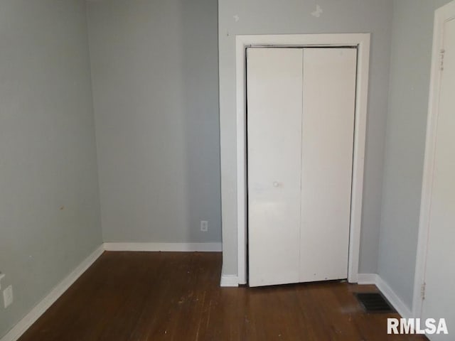 unfurnished bedroom featuring dark hardwood / wood-style floors