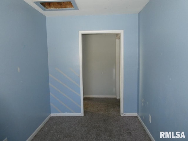 unfurnished room featuring dark carpet