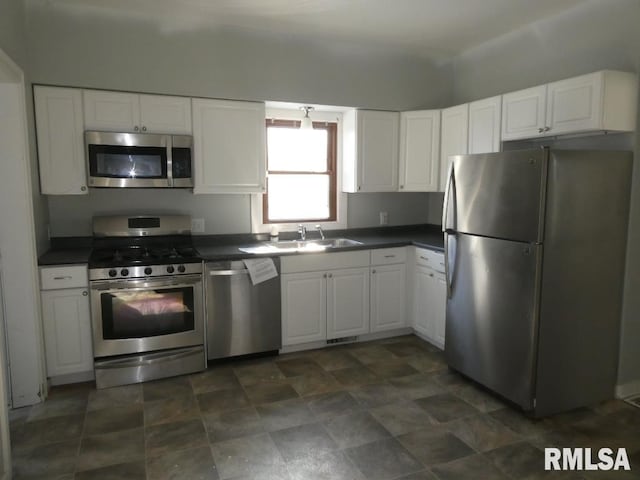 kitchen with sink, white cabinetry, and appliances with stainless steel finishes