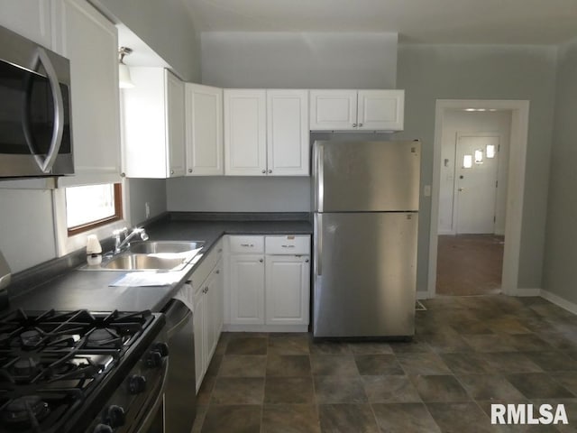 kitchen with white cabinets, appliances with stainless steel finishes, and sink