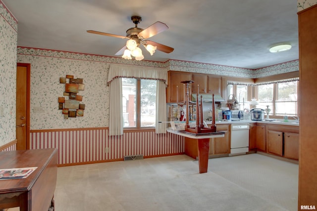 kitchen featuring light carpet, sink, plenty of natural light, and dishwasher