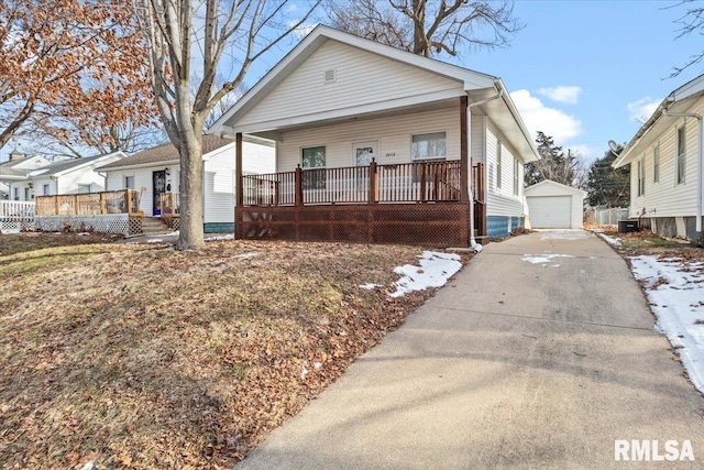 bungalow-style house with an outdoor structure, a porch, and a garage