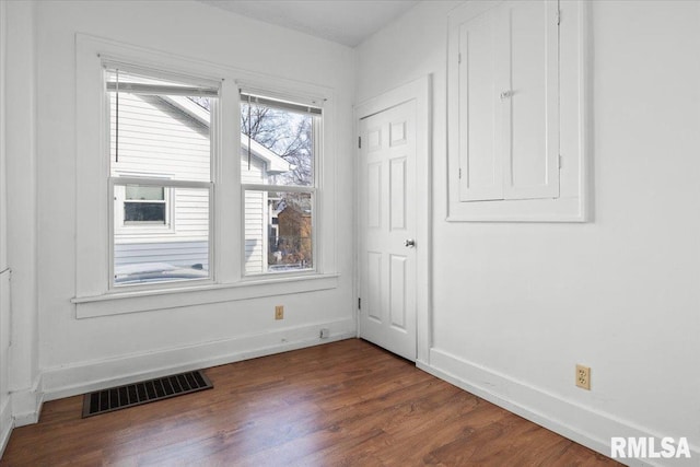 unfurnished room with dark hardwood / wood-style flooring