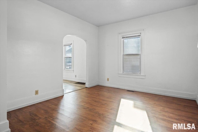 empty room with dark wood-type flooring