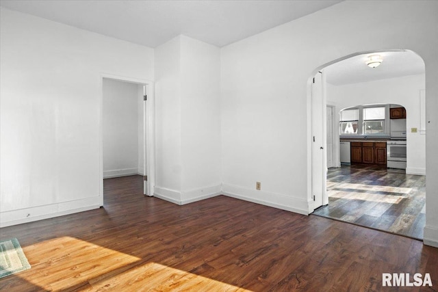 spare room with dark hardwood / wood-style flooring