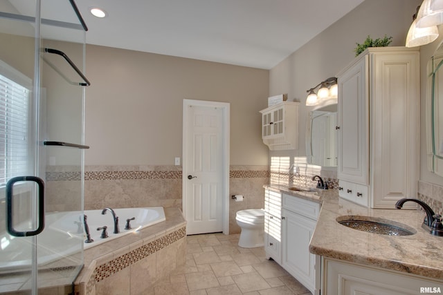 full bathroom with vanity, toilet, and separate shower and tub