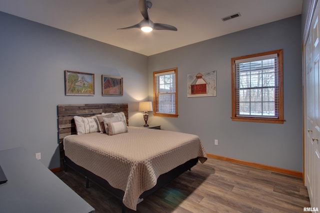 bedroom featuring ceiling fan, hardwood / wood-style floors, and a closet