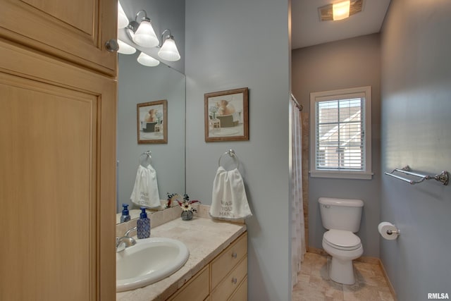 bathroom with toilet and vanity