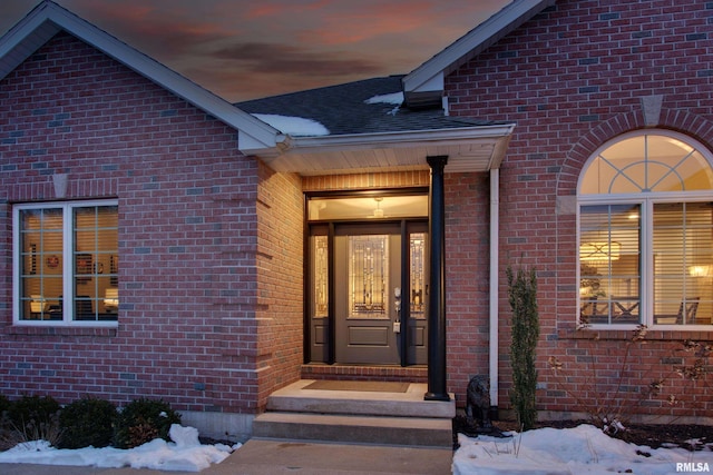 view of snow covered property entrance