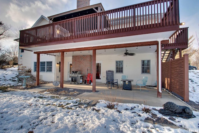 snow covered property featuring a patio area, a deck, and ceiling fan