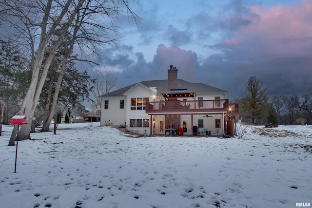 snow covered house with a deck