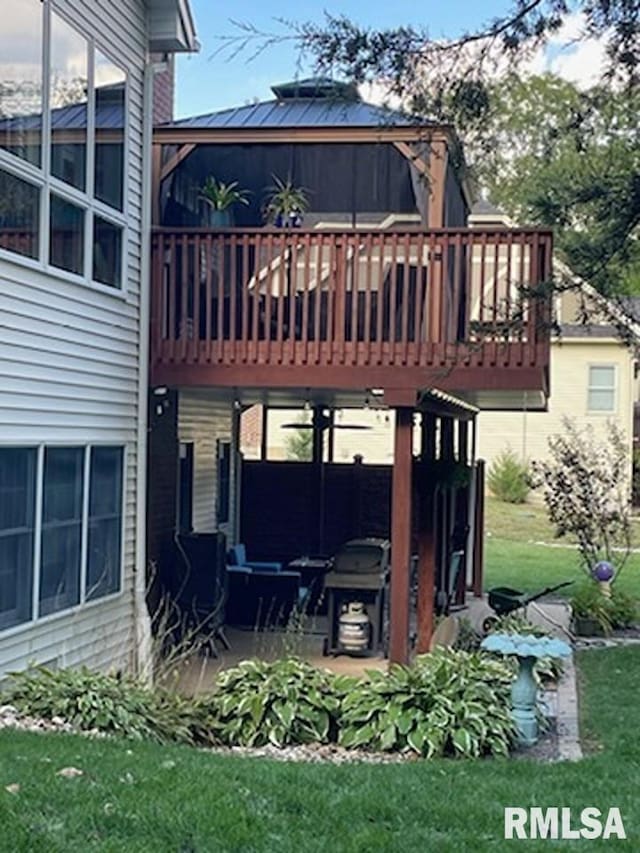 back of house with a lawn and a wooden deck