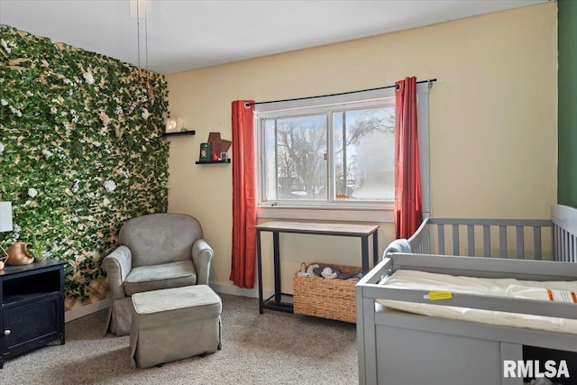 carpeted bedroom featuring a crib