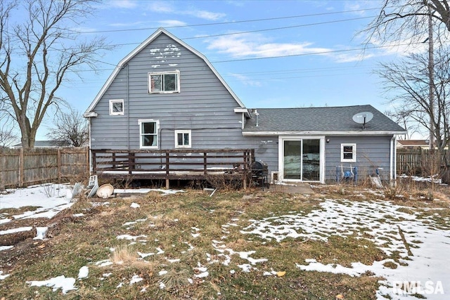 view of snow covered rear of property