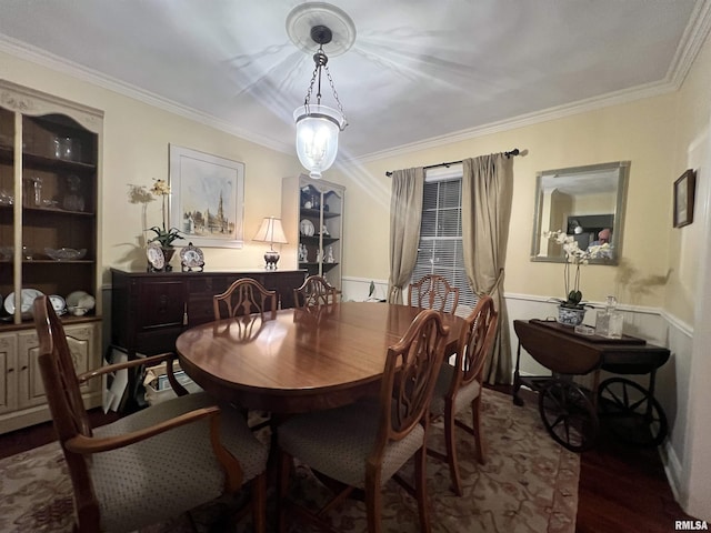 dining space with hardwood / wood-style flooring and crown molding