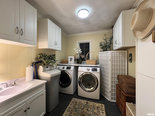 laundry room with separate washer and dryer, dark tile patterned flooring, cabinets, sink, and ornamental molding