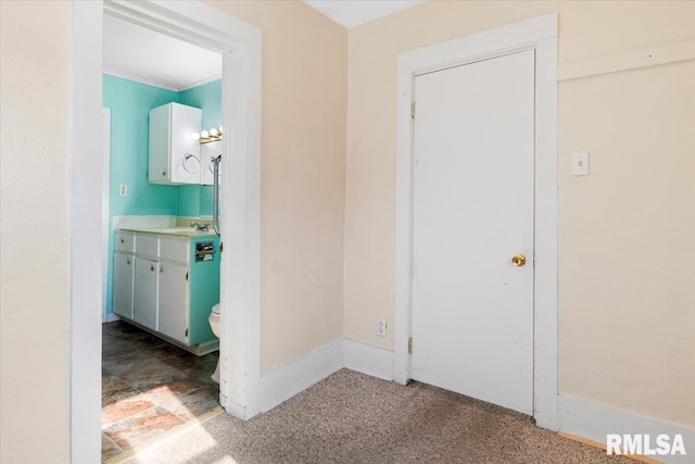 hall with carpet flooring and sink