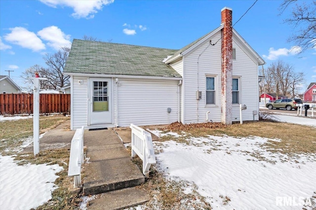 view of snow covered rear of property