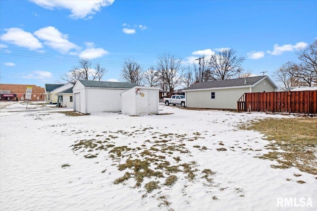 snow covered property featuring an outdoor structure