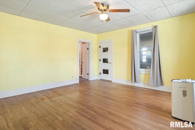 empty room with light hardwood / wood-style flooring and ceiling fan