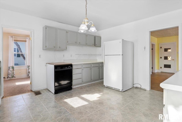 kitchen featuring white refrigerator, gray cabinets, decorative light fixtures, and dishwasher