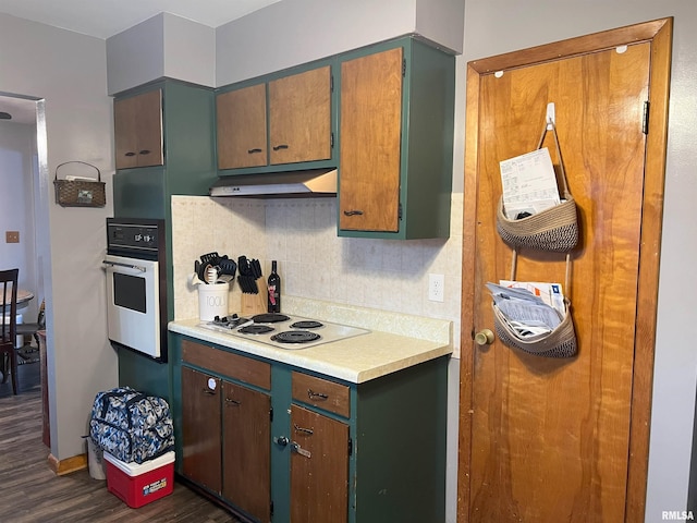 238 E Prairie St, Roodhouse, IL 62082 - kitchen with tasteful backsplash, white electric cooktop, dark hardwood / wood-style floors, and oven