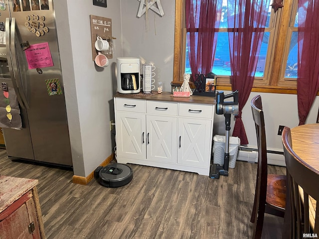 238 E Prairie St, Roodhouse, IL 62082 - interior space featuring wood-type flooring, stainless steel fridge, and a baseboard radiator